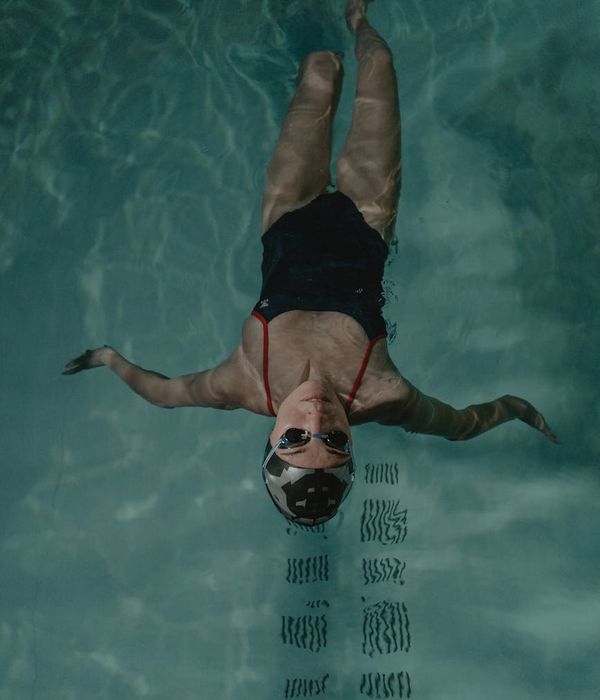 Woman performing a fluid motion exercise in a calm environment.